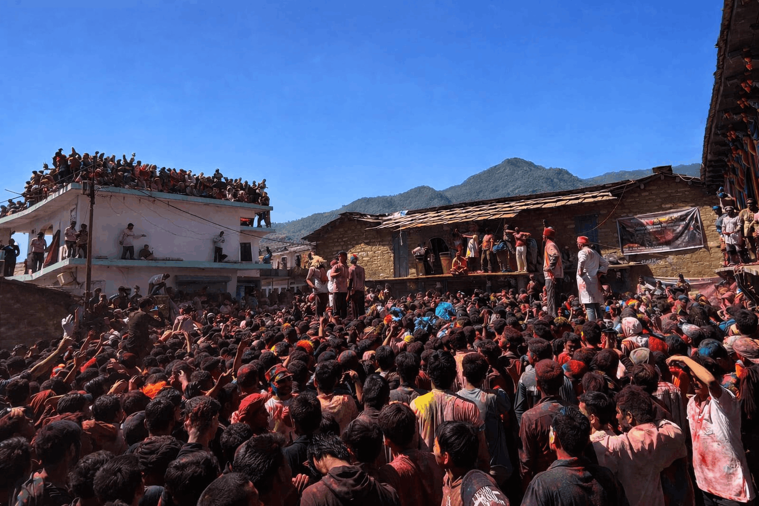 Traditional Holi celebrations in the town of Gopeshwar, featuring locals playing with organic colors near the ancient Gopinath Temple area